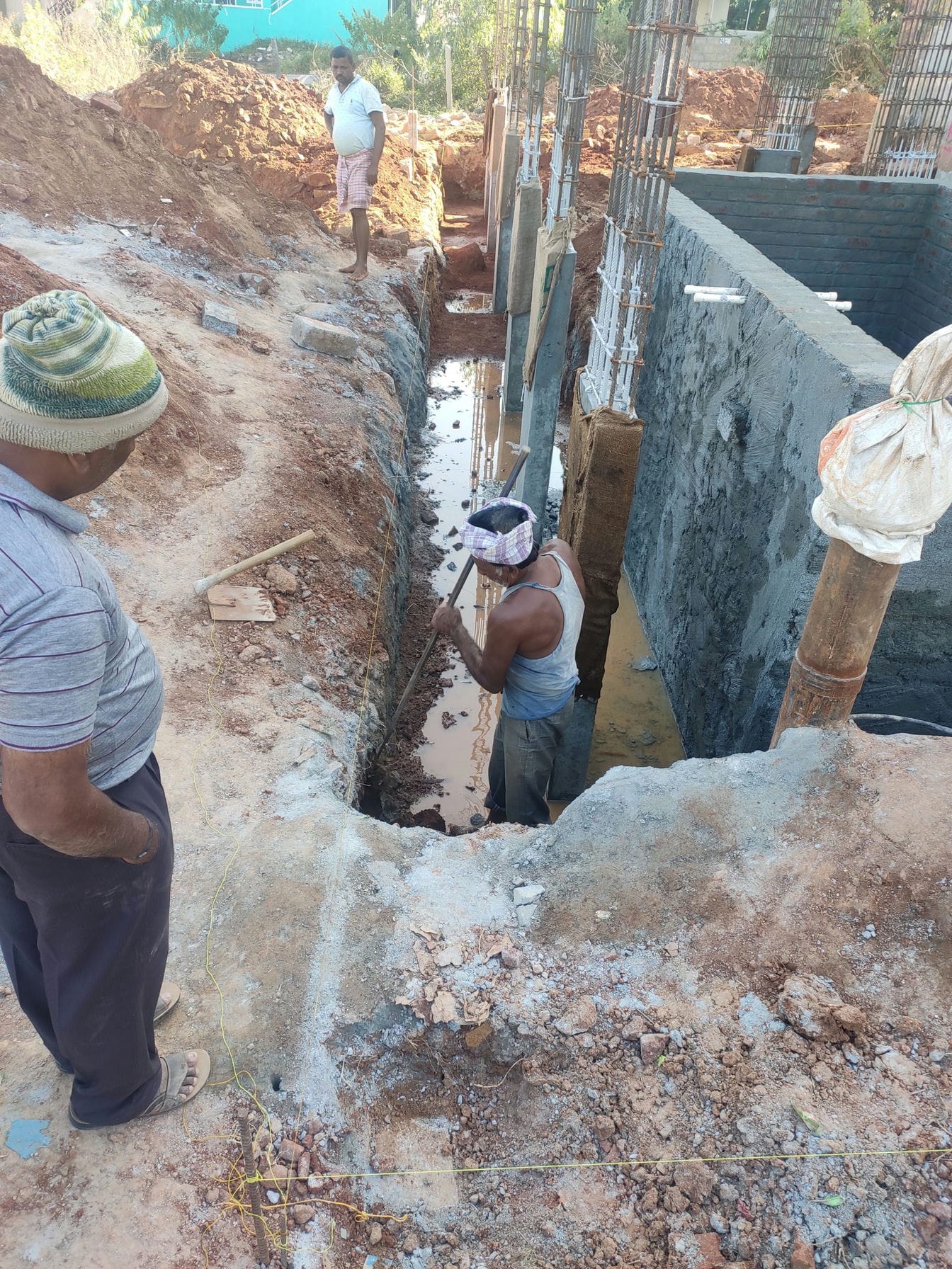 labourer digging trench on site boundry 